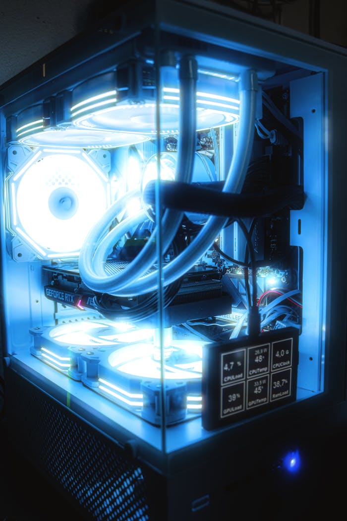 Services High-performance gaming PC setup featuring blue LED lighting and advanced cooling system.