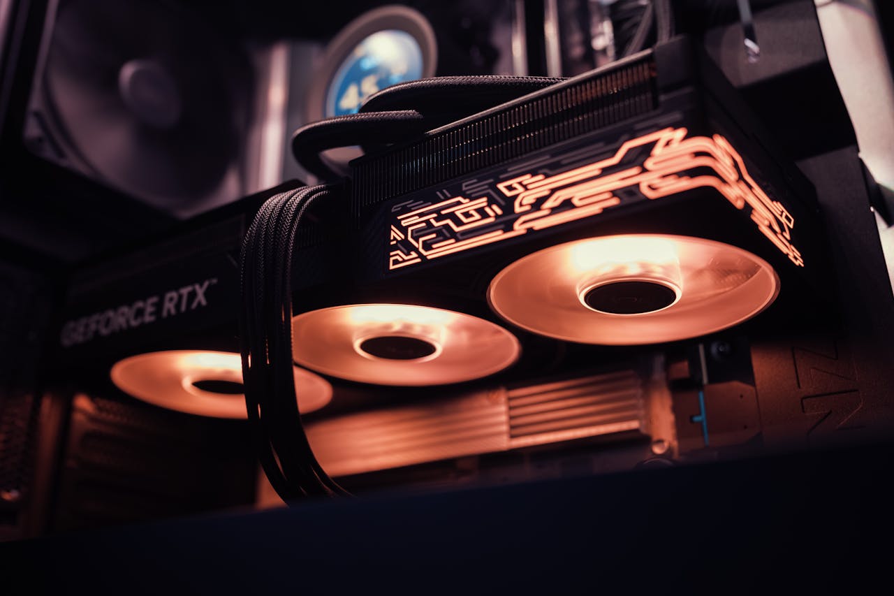 Services Detailed image of a GeForce RTX GPU with glowing LED lights inside a computer case.